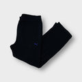 Puma fleece pants in black featuring a small purple embroidered logo on the thigh