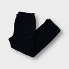 Puma fleece pants in black featuring a small purple embroidered logo on the thigh