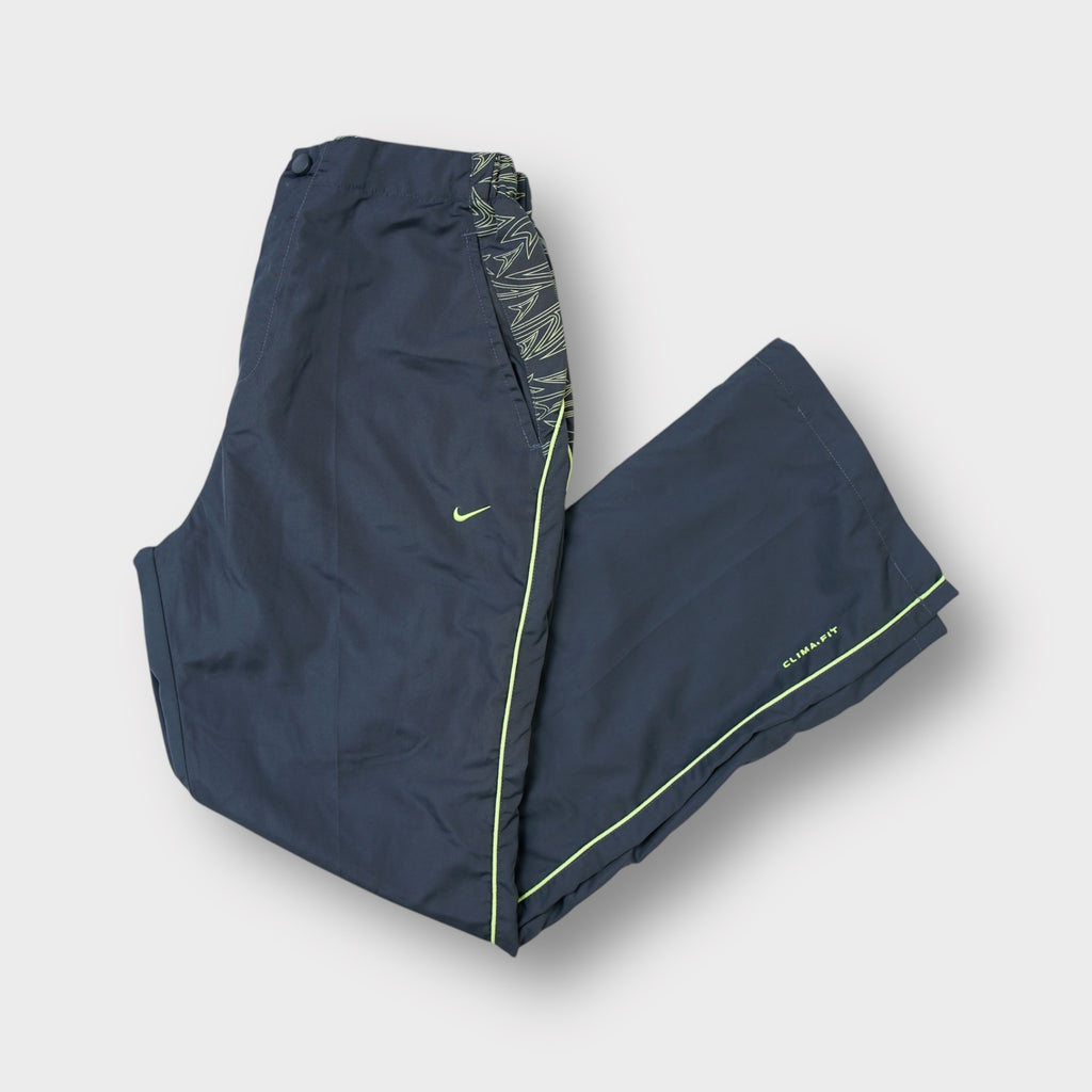 Nike track pants in grey with patterned waist trim, neon piping, and an embroidered logo.