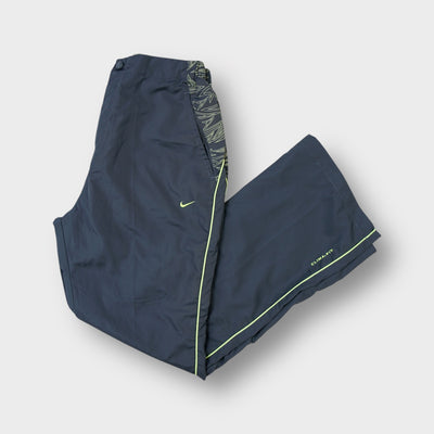 Nike track pants in grey with patterned waist trim, neon piping, and an embroidered logo.