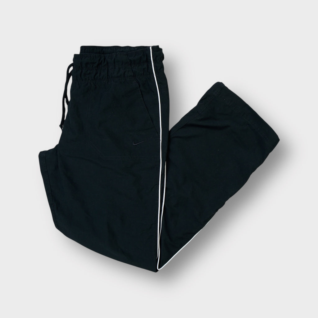 Nike black trackpants featuring white side piping and an elasticated waistband