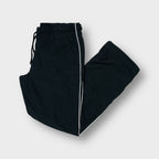 Nike black trackpants featuring white side piping and an elasticated waistband