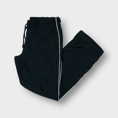 Nike black trackpants featuring white side piping and an elasticated waistband