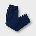 Lacoste trackpants in navy blue featuring an embroidered crocodile logo on the hip.