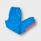 Vintage Nike blue trackpants featuring pink contrast panels and a Nike International patch