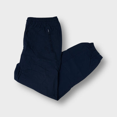 Reebok trackpants in black featuring an embroidered vector logo and zipped pocket