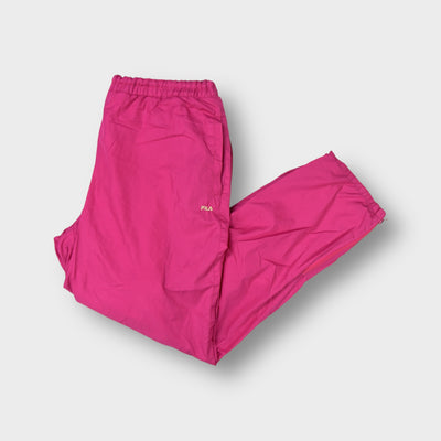 Fila trackpants in pink featuring an embroidered hip logo and zipped hem details