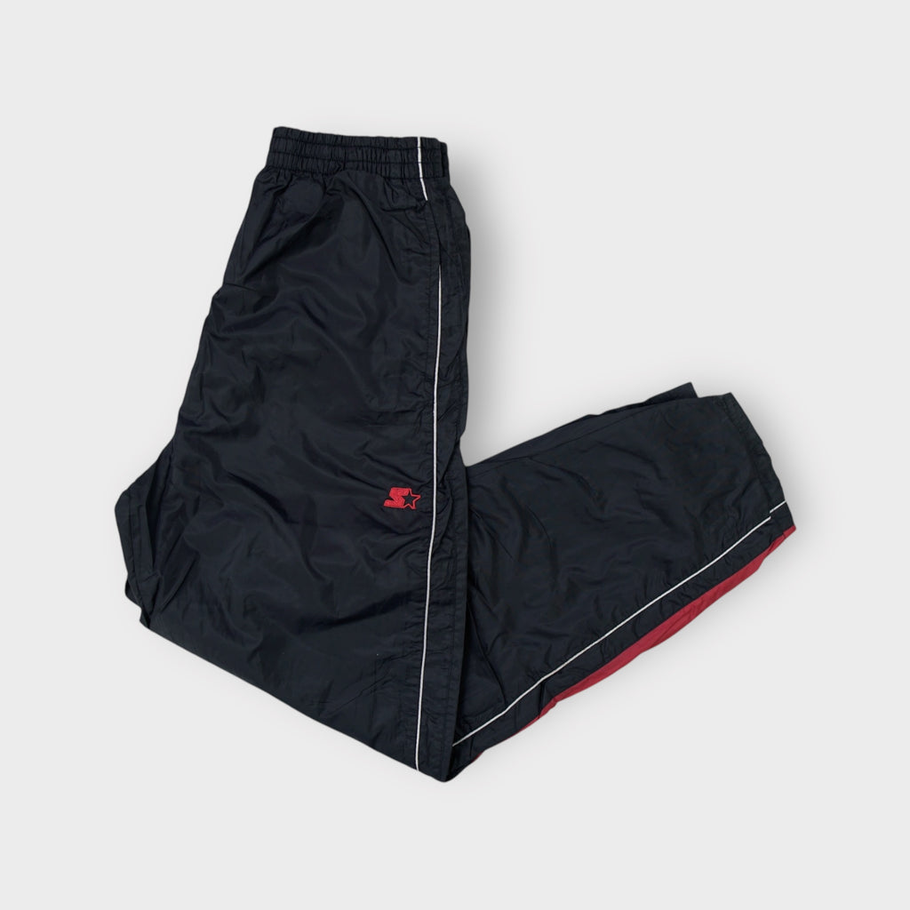 Starter black trackpants with white side piping and a small red embroidered logo near the waist.