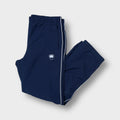 Nike trackpants in navy blue featuring white side piping and an embroidered hip crest
