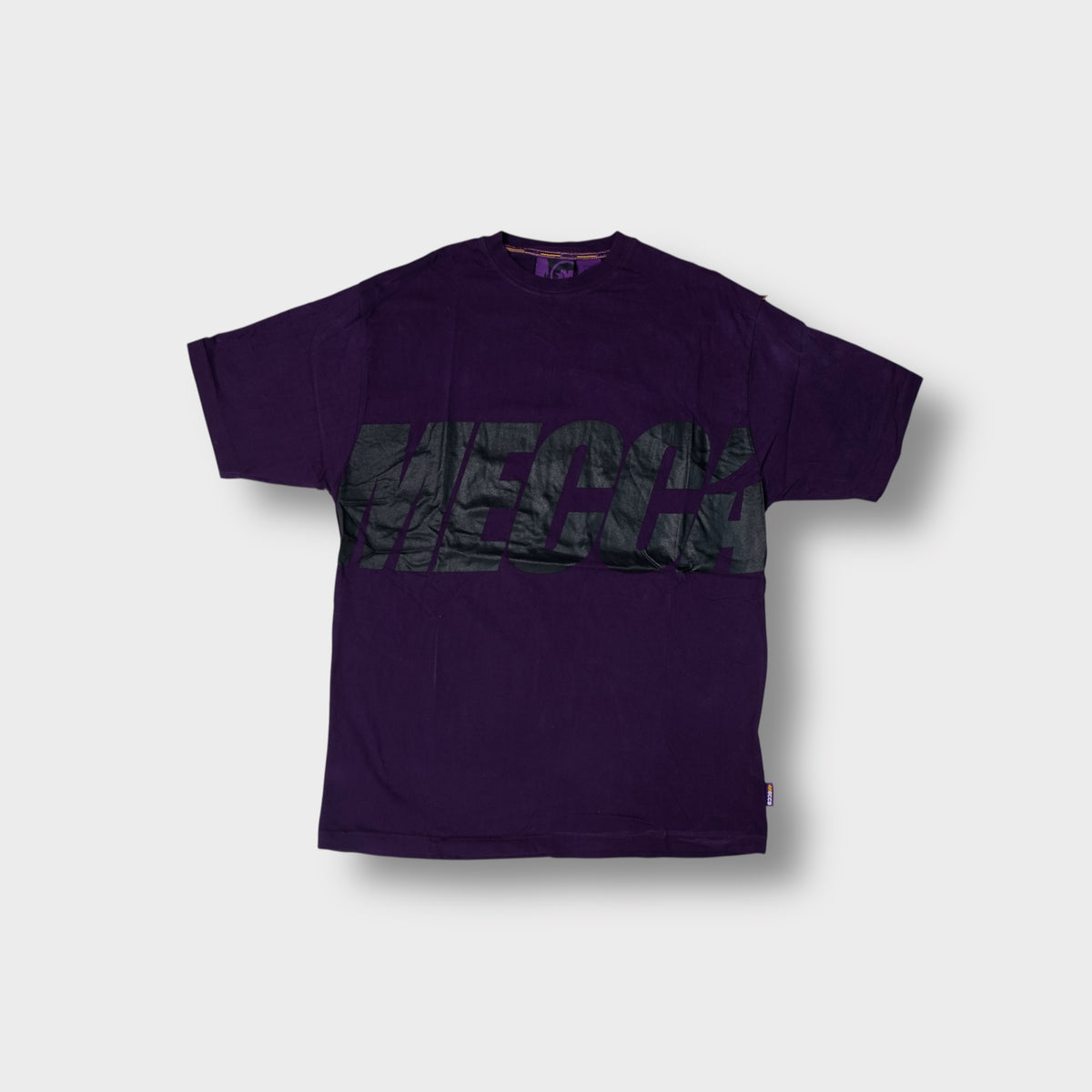 Mecca T-Shirt in purple featuring a large black logo printed across the chest