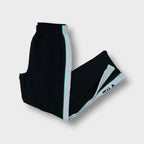 Black Fila trackpants with white side stripes and embroidered logo on the lower leg