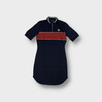Adidas polo shirt in navy blue featuring a red chest stripe and embroidered logo