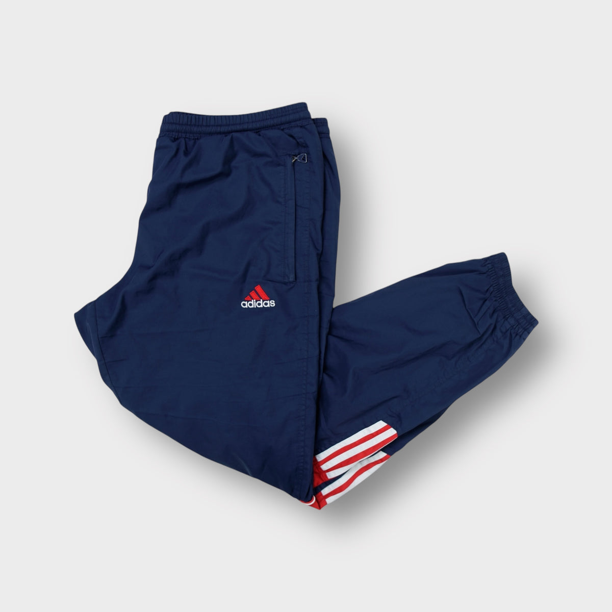 Adidas navy blue trackpants with red embroidered logo and side stripes
