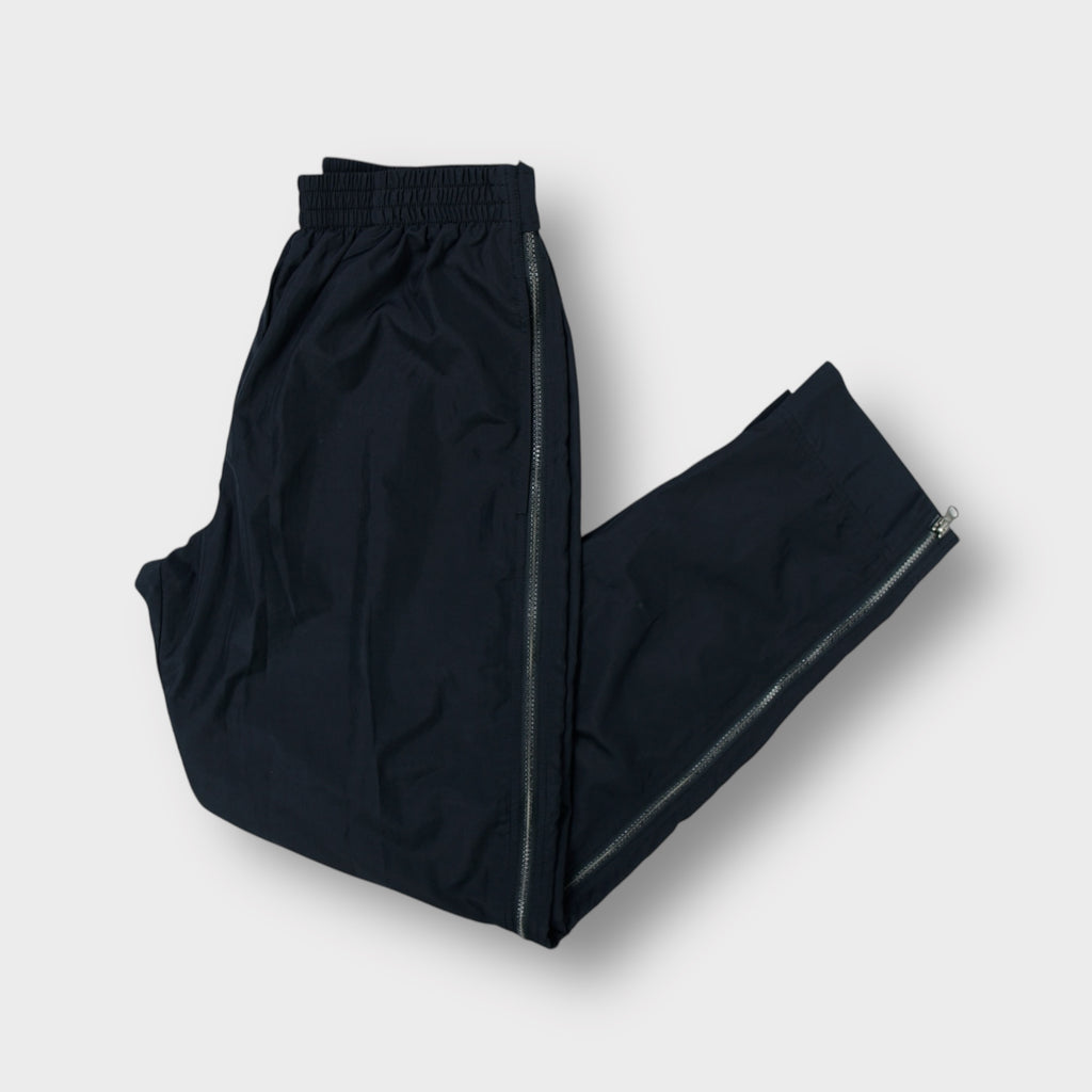 Nike track pants in black featuring full side zips and embroidered swoosh logo