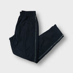 Nike track pants in black featuring full side zips and embroidered swoosh logo