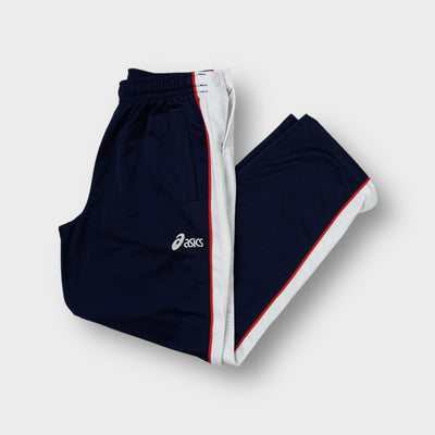 Asics trackpants in navy blue featuring white side stripes and an embroidered logo.