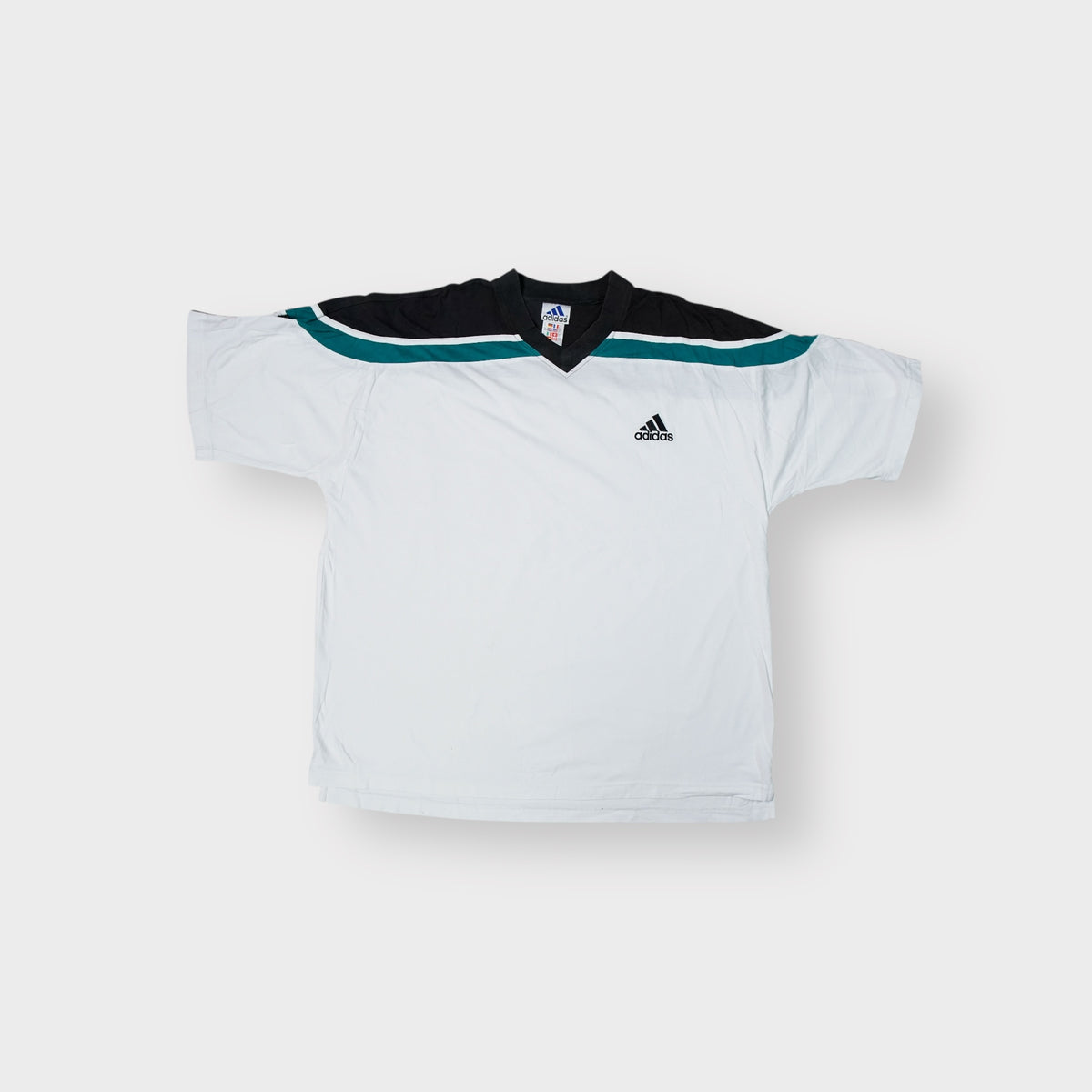 Adidas vintage shirt in white featuring black and green shoulder panels and a V-neck