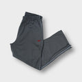 Reebok grey trackpants featuring a red embroidered vector logo on the leg and white side piping.