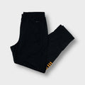 Black Adidas trackpants with gold lower-leg stripes and embroidered logos