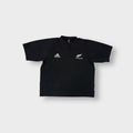 Black Adidas shirt with white embroidered Adidas and All Blacks fern logos on the chest.