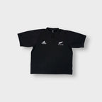 Black Adidas shirt with white embroidered Adidas and All Blacks fern logos on the chest.