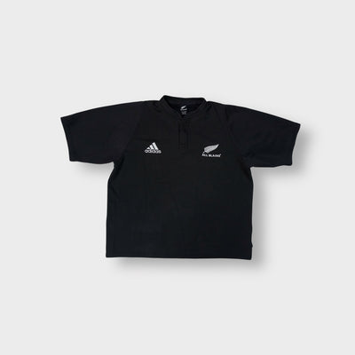 Black Adidas shirt with white embroidered Adidas and All Blacks fern logos on the chest.