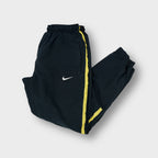 Nike black trackpants with yellow side stripes and embroidered white swoosh logo