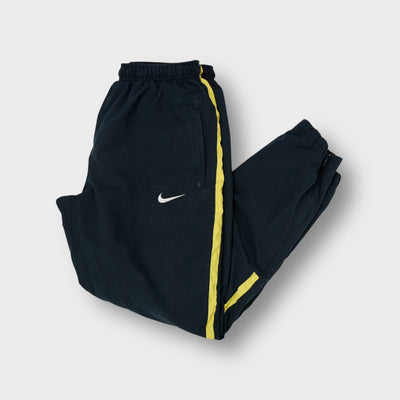 Nike black trackpants with yellow side stripes and embroidered white swoosh logo