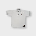 Beige Puma polo shirt in plush nici material featuring an embroidered cat logo on chest
