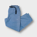 Blue Nike pants with an integrated black belt and embroidered mini swoosh logo