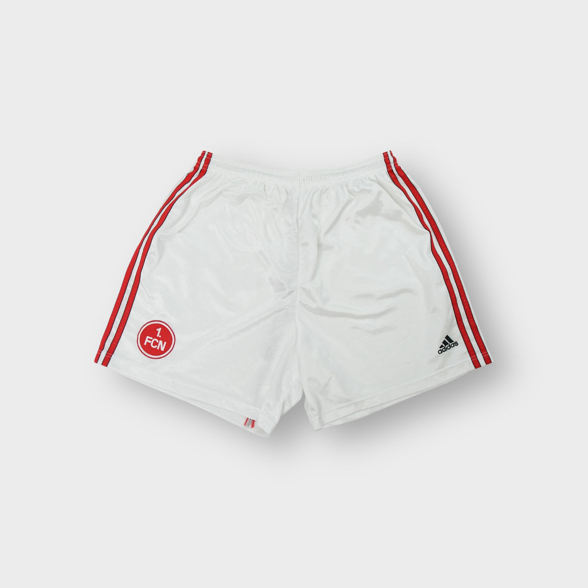 Adidas white shorts with red side stripes and an embroidered 1. FC Nürnberg crest