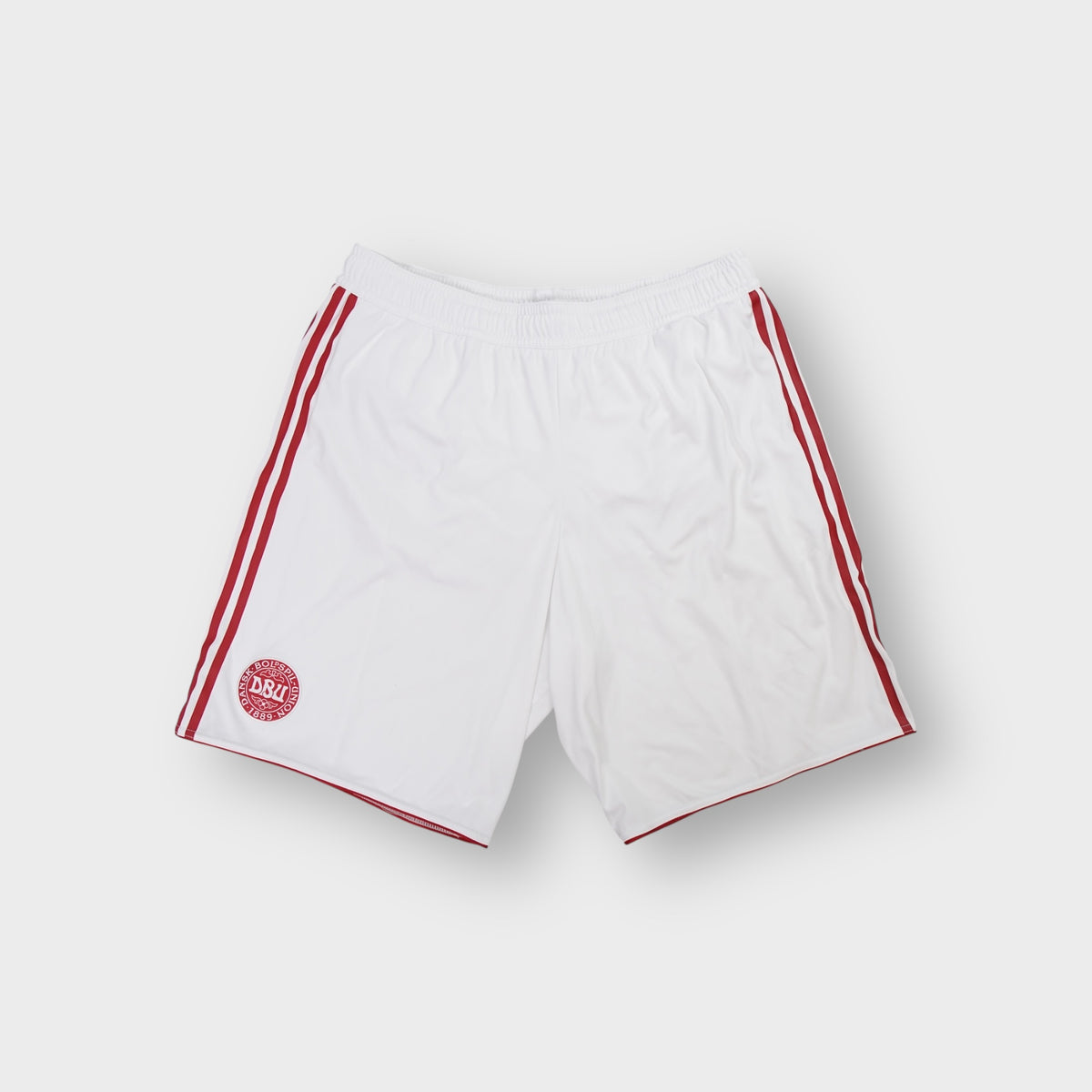 White Adidas Denmark shorts with red side stripes and an embroidered national team crest.