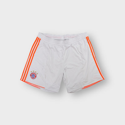 Adidas FC Bayern white shorts featuring orange side stripes and an embroidered crest
