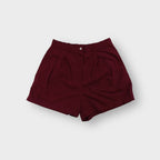 Nike shorts in red with front pleats, button waistband and tonal embroidered logo