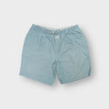Nike turquoise shorts featuring an integrated webbed belt and front Nike Air patch