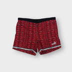 Red Puma vintage shorts with graphic print and embroidered white logo on the hem