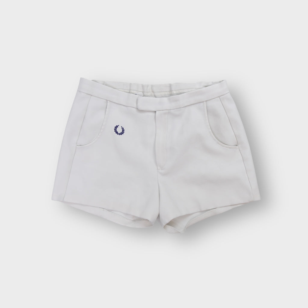 White Fred Perry vintage shorts with embroidered navy blue laurel wreath logo on the hip.