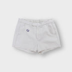 White Fred Perry vintage shorts with embroidered navy blue laurel wreath logo on the hip.