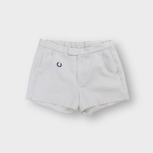 White Fred Perry vintage shorts with embroidered navy blue laurel wreath logo on the hip.
