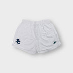 Nike white 90s shorts featuring an embroidered dark green SC emblem on the hem