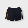 Nike athletic shorts in gray featuring yellow side panel stripes and an embroidered swoosh logo.