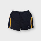Nike athletic shorts in gray featuring yellow side panel stripes and an embroidered swoosh logo.