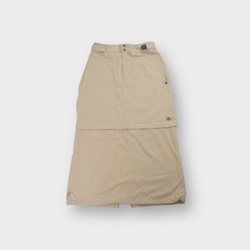 Nike ACG beige convertible skirt pants featuring an embroidered logo near the hem