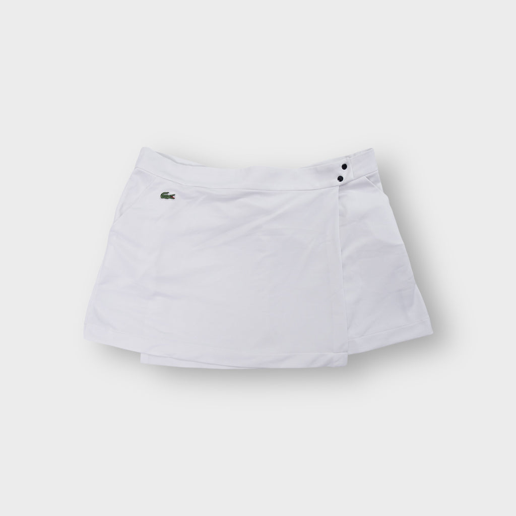 Lacoste white tennis skirt featuring an embroidered crocodile logo on the pocket