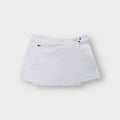 Lacoste white tennis skirt featuring an embroidered crocodile logo on the pocket