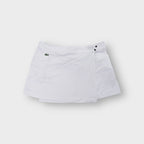 Lacoste white tennis skirt featuring an embroidered crocodile logo on the pocket