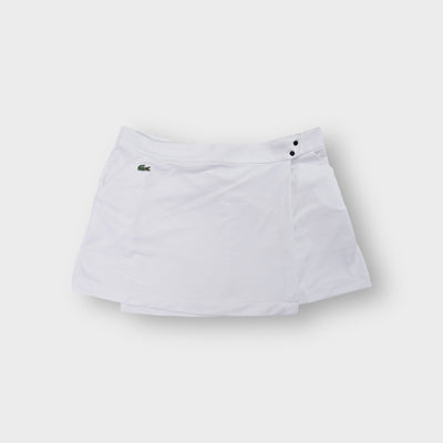 Lacoste white tennis skirt featuring an embroidered crocodile logo on the pocket