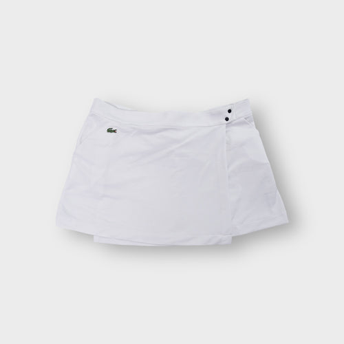 Lacoste white tennis skirt featuring an embroidered crocodile logo on the pocket