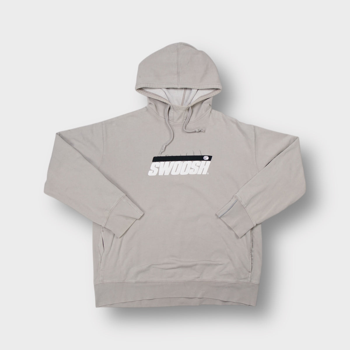 Nike hoodie in beige with an embroidered Swoosh graphic across the chest