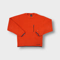 Orange Nike fleece sweater featuring a vertical zipped chest pocket and crewneck cut